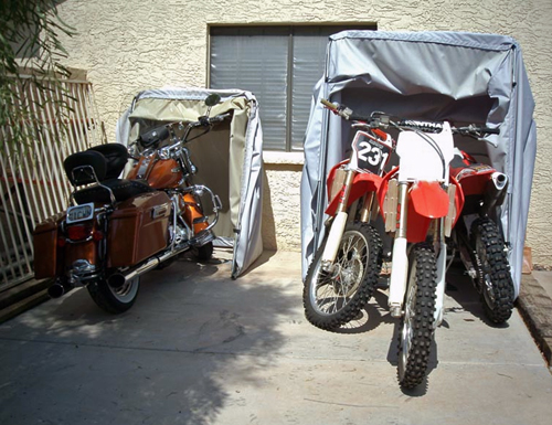 Harley Road King in a standard bike barn cover and three dirt bikes in one tourer model bike barn